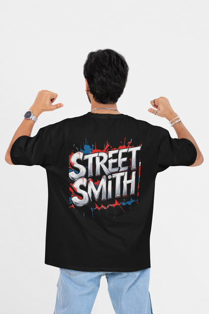 Person wearing a black oversized t-shirt with 'Street Smith' design on the back, against a white background